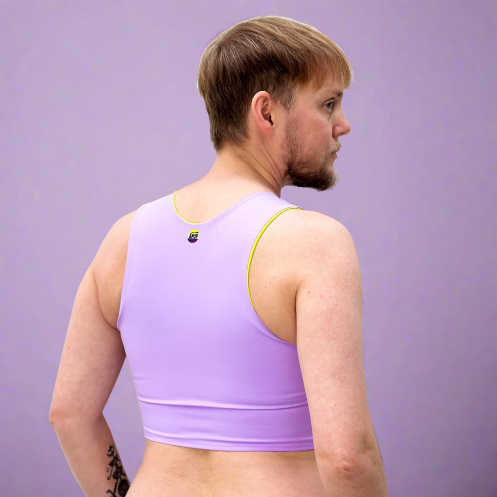 Non-binary person wearing lilac coloured chest binder