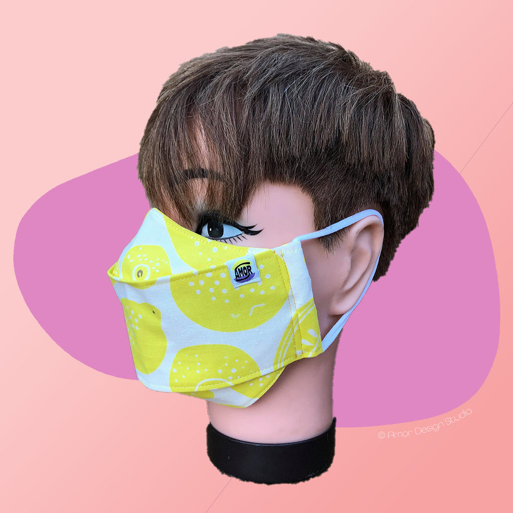 White face mask with lemons print, on model - side