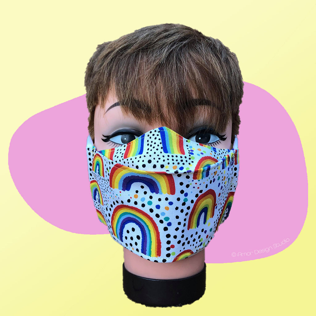 White face mask with rainbows and spots, on model - front