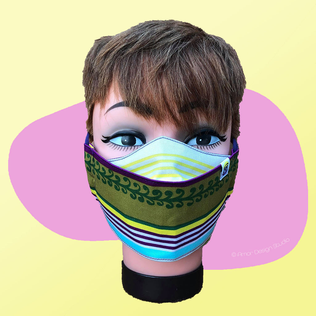 Face mask with green, yellow, blue and cream stripes on model - front