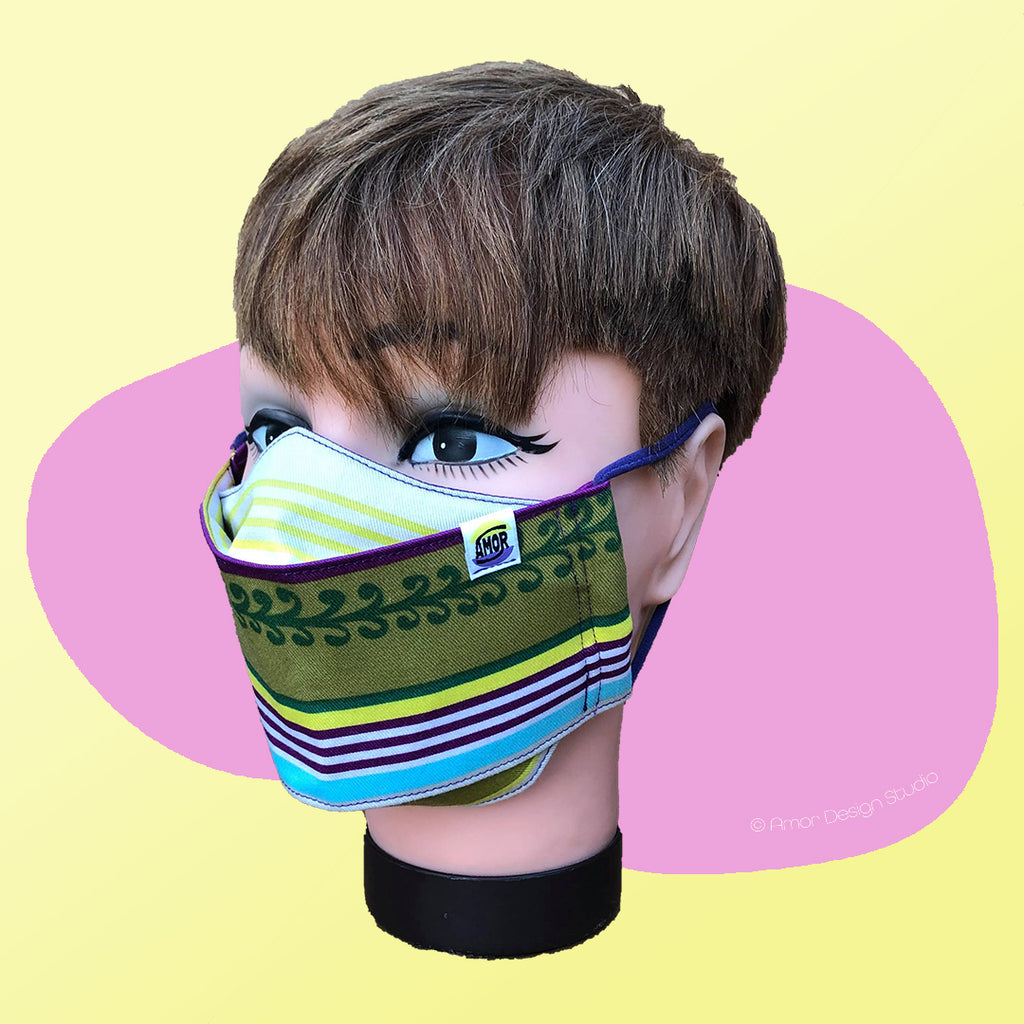 Face mask with green, yellow, blue and cream stripes on model - side