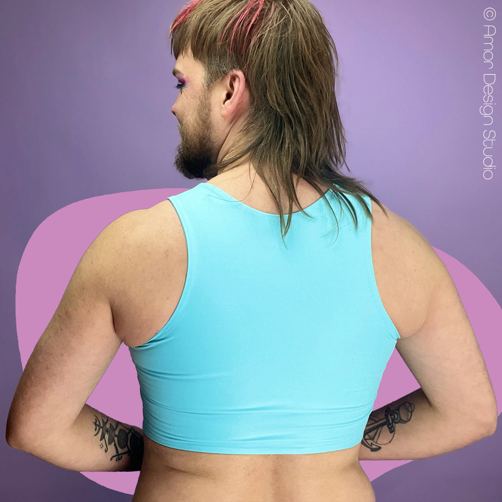Nonbinary trans person wearing pastel blue reversible chest binder, back.
