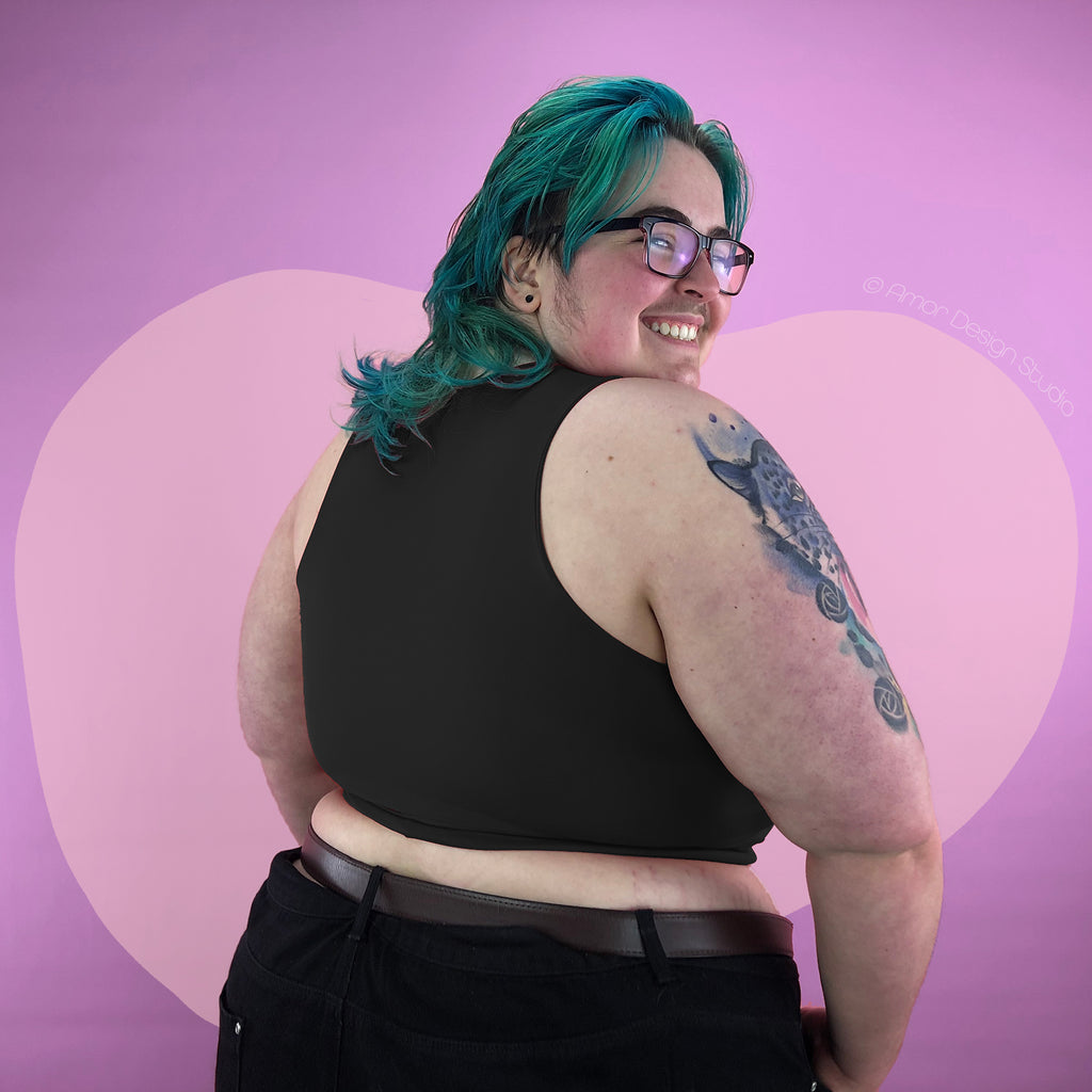Plus size nonbinary trans man wearing black mid length, Amor full chest binder. Size-inclusive, large chest. Back view.