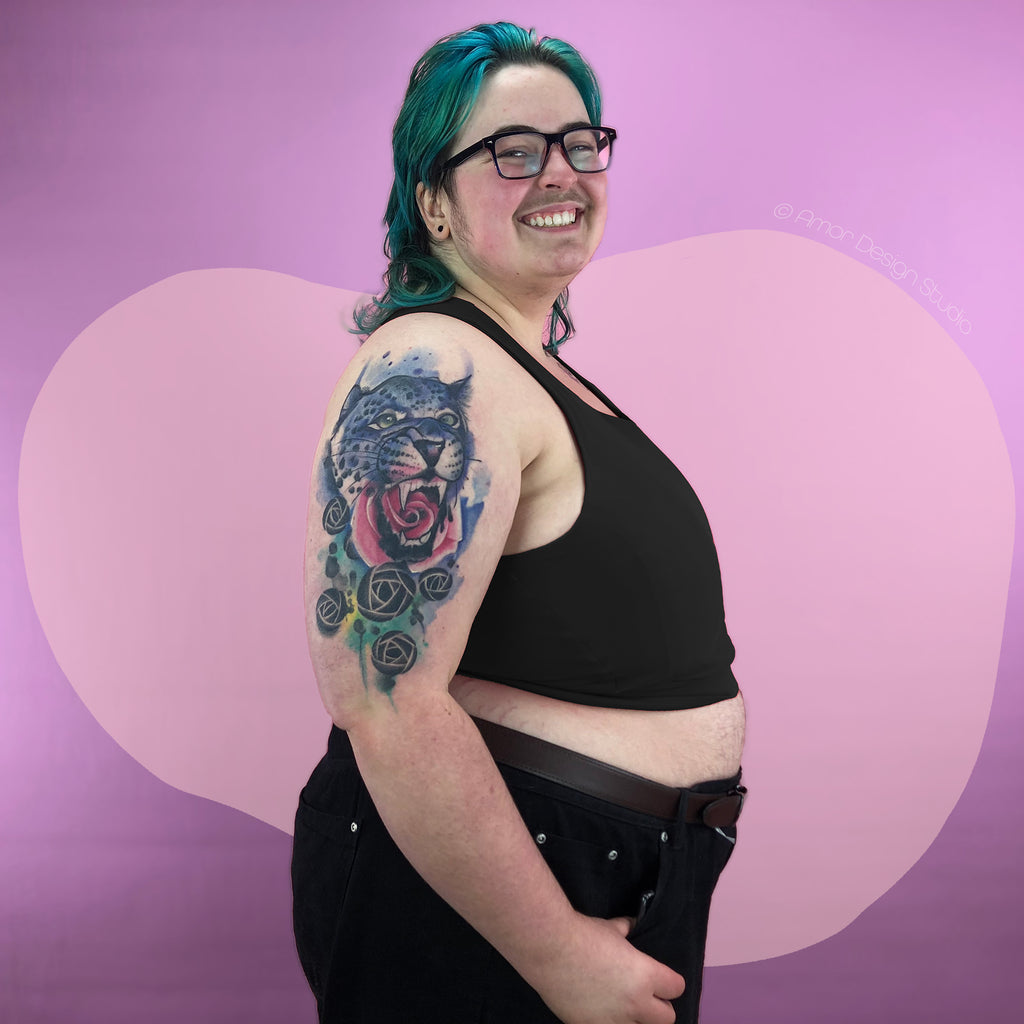 Plus size nonbinary trans man wearing black mid length, Amor full chest binder. Size-inclusive, large chest.