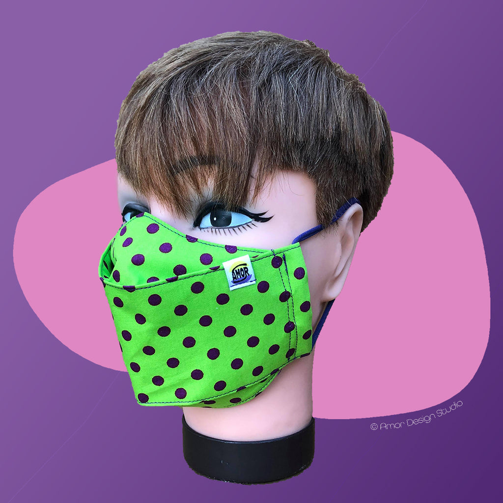 Acid green face mask with dark purple polka dots, on model - side